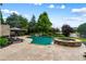 Backyard oasis with beautiful pool, spa, waterfall feature, and extensive patio for entertaining at 938 Crescent River Pass, Suwanee, GA 30024