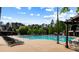 Large community pool surrounded by lounge chairs, landscaping, and a clubhouse in the background at 938 Crescent River Pass, Suwanee, GA 30024