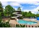 Community pool area with a fun water slide and lush greenery, perfect for Gathering enjoyment at 938 Crescent River Pass, Suwanee, GA 30024