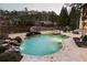 An aerial view of a pool with a waterfall feature and lounge chairs at 938 Crescent River Pass, Suwanee, GA 30024