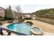 Stunning aerial view of a backyard pool and hot tub overlooking the lake at 938 Crescent River Pass, Suwanee, GA 30024