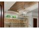 Elegant shower design with bronze fixtures, stonework, and a wood ceiling at 938 Crescent River Pass, Suwanee, GA 30024