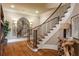 Elegant staircase with wood and iron accents and hardwood floors at 938 Crescent River Pass, Suwanee, GA 30024