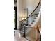 Elegant curved staircase with dark wood railings and iron spindles at 938 Crescent River Pass, Suwanee, GA 30024