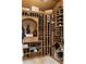 The wine cellar features custom wood shelving and ample storage for wine bottles at 938 Crescent River Pass, Suwanee, GA 30024
