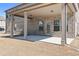 A covered back porch features brick pillars and a concrete patio at 141 Aylesbury Blvd, Mcdonough, GA 30252