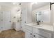 Bathroom with dual sinks, white cabinets, and tiled flooring at 141 Aylesbury Blvd, Mcdonough, GA 30252