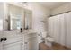 Bright bathroom with white vanity, a shower with a curtain, and tile floors at 141 Aylesbury Blvd, Mcdonough, GA 30252