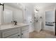 Bathroom with dual sinks, white cabinets, and tiled flooring at 141 Aylesbury Blvd, Mcdonough, GA 30252