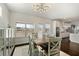 Bright dining area features a modern light fixture, dark floors, and opens to the kitchen at 141 Aylesbury Blvd, Mcdonough, GA 30252