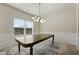 Dining room with modern lighting fixture and large table near window at 141 Aylesbury Blvd, Mcdonough, GA 30252