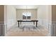 Formal dining room with modern lighting fixture, chair rail and neutral colors at 141 Aylesbury Blvd, Mcdonough, GA 30252