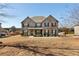 Traditional brick home featuring a manicured front lawn and mature landscaping at 141 Aylesbury Blvd, Mcdonough, GA 30252