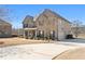 Charming two-story brick home featuring a manicured lawn, covered porch, and an attached two-car garage at 141 Aylesbury Blvd, Mcdonough, GA 30252