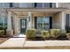 Charming front porch with classic columns and beautifully trimmed shrubs at 141 Aylesbury Blvd, Mcdonough, GA 30252