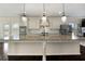 Close up of a kitchen island with granite countertops and pendant lights at 141 Aylesbury Blvd, Mcdonough, GA 30252