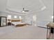 Spacious main bedroom with white walls, carpet flooring, tray ceiling, fan, and lots of natural light at 141 Aylesbury Blvd, Mcdonough, GA 30252