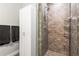 Bathroom featuring a tiled shower with a glass door and built in shelving at 270 17Th Nw St # 2002, Atlanta, GA 30363