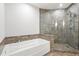 Spacious bathroom with a soaking tub and tiled shower with glass enclosure at 270 17Th Nw St # 2002, Atlanta, GA 30363