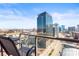 Balcony view showcasing modern city buildings on a clear day, with seating for outdoor enjoyment at 270 17Th Nw St # 2002, Atlanta, GA 30363