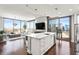 Bright, modern kitchen with stainless steel appliances, a white island, and a stunning city view at 270 17Th Nw St # 2002, Atlanta, GA 30363