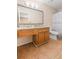 Bathroom featuring a vanity with granite countertops and a coordinating framed mirror at 308 Gettysburg Pl, Atlanta, GA 30350