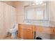 A well-lit bathroom with granite countertops, a framed mirror, and a patterned shower curtain at 308 Gettysburg Pl, Atlanta, GA 30350