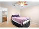 A cozy bedroom includes an adjoining bathroom and a ceiling fan at 308 Gettysburg Pl, Atlanta, GA 30350