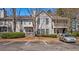 Inviting townhome featuring a neutral exterior, balcony, mature landscaping and parking at 308 Gettysburg Pl, Atlanta, GA 30350