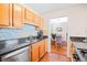 Modern kitchen boasting stainless steel appliances, hardwood floors, and granite countertops at 308 Gettysburg Pl, Atlanta, GA 30350