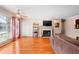 Bright living room featuring hardwood floors, a fireplace, and large windows at 308 Gettysburg Pl, Atlanta, GA 30350