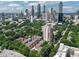 Aerial shot of complex with surrounding greenery and Atlanta skyline in the background at 375 Ralph Mcgill Ne Blvd # 1402, Atlanta, GA 30312