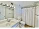 Cozy bathroom with vanity sink, updated lighting, and shower with a curtain at 375 Ralph Mcgill Ne Blvd # 1402, Atlanta, GA 30312