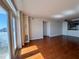 Sunlit living room features gleaming wood floors, fan, and access to the balcony at 375 Ralph Mcgill Ne Blvd # 1402, Atlanta, GA 30312