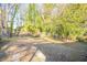 Large, grassy backyard with mature trees providing shade at 928 Magna Carta Nw Dr, Atlanta, GA 30318