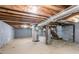 Spacious unfinished basement with exposed wood beams and cement floor at 928 Magna Carta Nw Dr, Atlanta, GA 30318