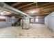 Unfinished basement with exposed HVAC, stairs, and block walls at 928 Magna Carta Nw Dr, Atlanta, GA 30318