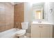 Bathroom featuring a vanity with storage, a framed mirror and a shower over tub with tiled walls at 928 Magna Carta Nw Dr, Atlanta, GA 30318