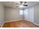 A quaint bedroom with hardwood floors, ceiling fan, and double door closet at 928 Magna Carta Nw Dr, Atlanta, GA 30318