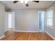 A spacious bedroom featuring gleaming hardwood floors and a modern ceiling fan at 928 Magna Carta Nw Dr, Atlanta, GA 30318