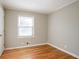 Cozy bedroom features hardwood floors and a bright window at 928 Magna Carta Nw Dr, Atlanta, GA 30318