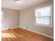 Bedroom features hardwood floors, two windows, and neutral paint at 928 Magna Carta Nw Dr, Atlanta, GA 30318