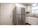 Corner kitchen with stainless steel refrigerator, sink, and white cabinets at 928 Magna Carta Nw Dr, Atlanta, GA 30318