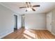 Sun-filled living room with hardwood floors, white trim, and multiple entryways at 928 Magna Carta Nw Dr, Atlanta, GA 30318