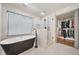Luxurious bathroom with a freestanding tub, glass-enclosed shower, and a walk-in closet for ample storage at 2357 Lynn Iris Dr, Decatur, GA 30032
