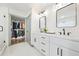 Bright bathroom featuring a double vanity, white cabinets, and a spacious walk-in closet at 2357 Lynn Iris Dr, Decatur, GA 30032