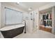 Bathroom featuring a black soaking tub, glass shower, and walk-in closet with custom shelving at 2357 Lynn Iris Dr, Decatur, GA 30032