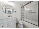Clean bathroom featuring a white vanity, toilet, and a glass-enclosed shower with herringbone tile at 2357 Lynn Iris Dr, Decatur, GA 30032