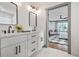 Well-lit bathroom with dual sinks, modern fixtures, and stylish mirrors with a view into the main bedroom at 2357 Lynn Iris Dr, Decatur, GA 30032