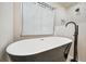Elegant bathroom featuring a freestanding tub with modern black fixtures and textured white tile walls at 2357 Lynn Iris Dr, Decatur, GA 30032